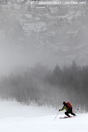 Skiing on the side of black ski slope, fog had disappeared for a moment and we could see down to the valley