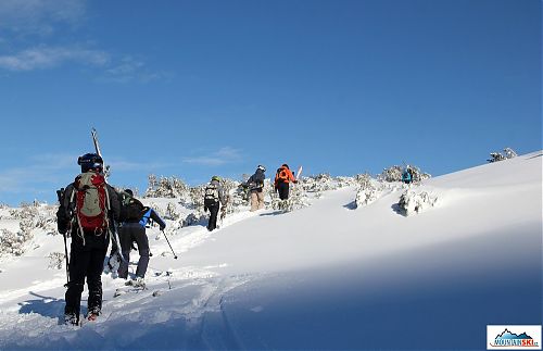 A short climb up in the powder of shadow downhill