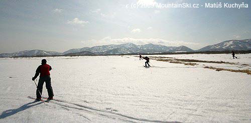 Mirka cross-country skiing on skialpinism equipment in forefront. Main person is Vseta nicely skiing on hard hardware skis Line and binding Marker Duke